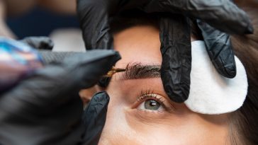 young woman getting beauty treatment her eyebrows