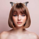 Woman_with_hairstyle_of_butterfly_haircut_with_bangs